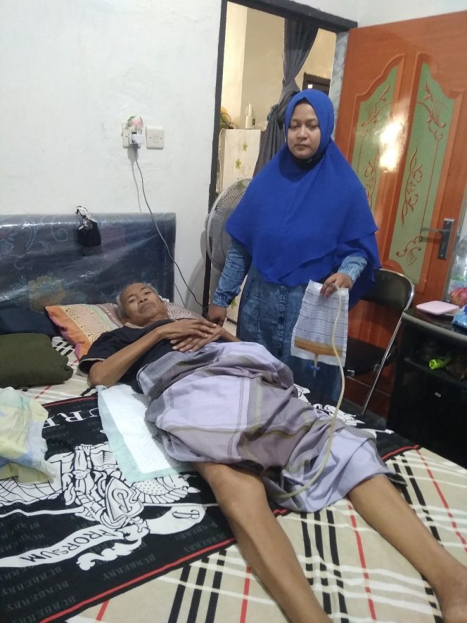 
					Ket foto: Haji Izmir terbaring lemah di dampingi isterinya (foto S.L Pohan)